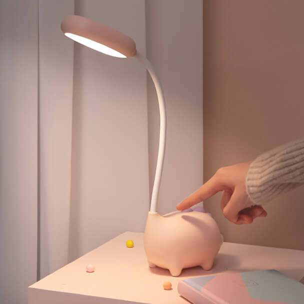 Eco-friendly T-Rex LED desk light for kids; whimsical dino shape, adjustable neck, soft eye-caring light; available in yellow