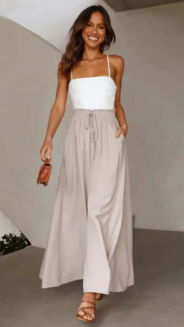 Women's effortless loose fit drawstring trousers paired with sandals for warm weather fashion.