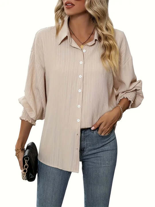 Stylish women's apricot blouse with delicate ruffles, a feminine long sleeve top for any occasion.