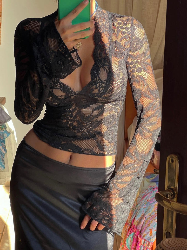 Women's sophisticated black floral V-neck long sleeve cropped top. Ideal for a party or fashion-forward night out.