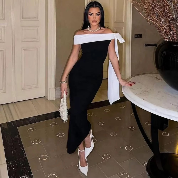 Women's sophisticated off-shoulder black midi dress. Ideal for evening events, parties, and formal gatherings.