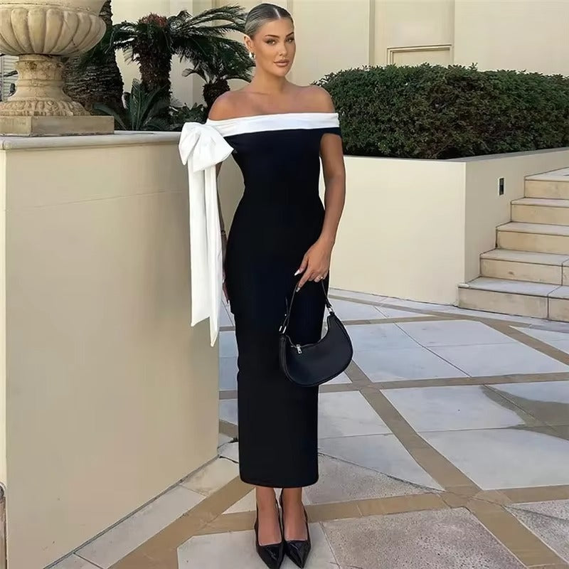 Women's elegant black off-shoulder midi dress, a chic evening gown. Perfect party wear for formal and special occasions.
