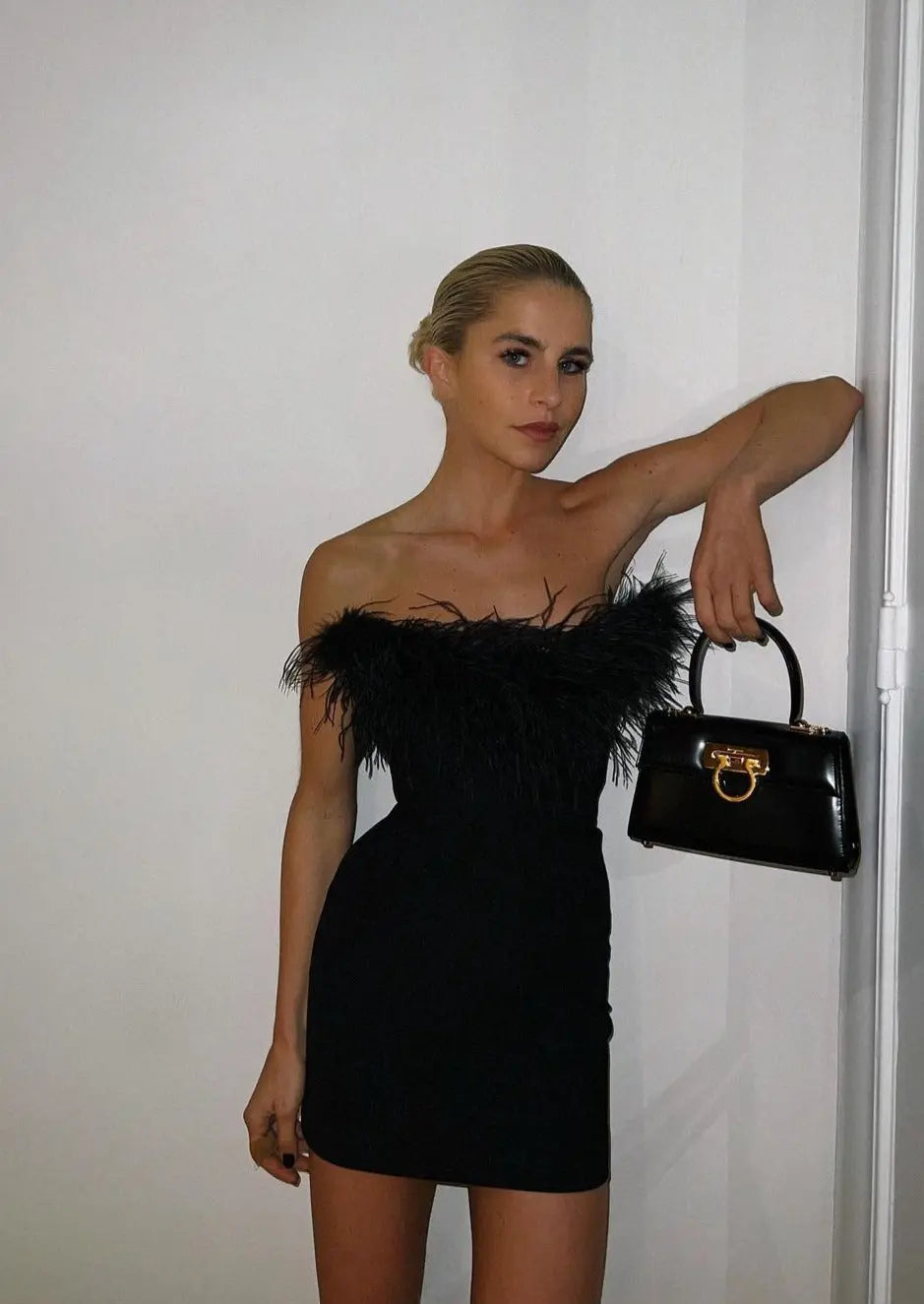 Elegant black off-shoulder mini dress for women. Perfect party, cocktail, or evening wear. Glamorous & stylish.