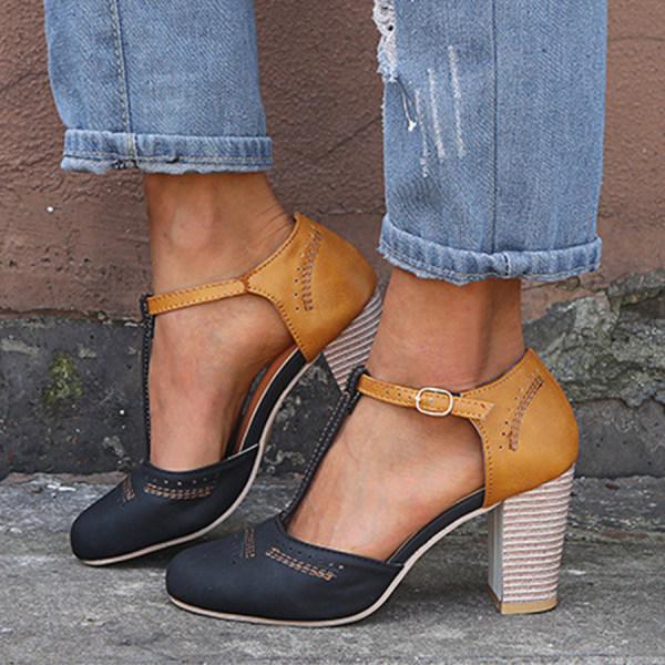 Women's vintage-inspired navy T-strap block heels, combining comfort with elegant dress shoe aesthetics.