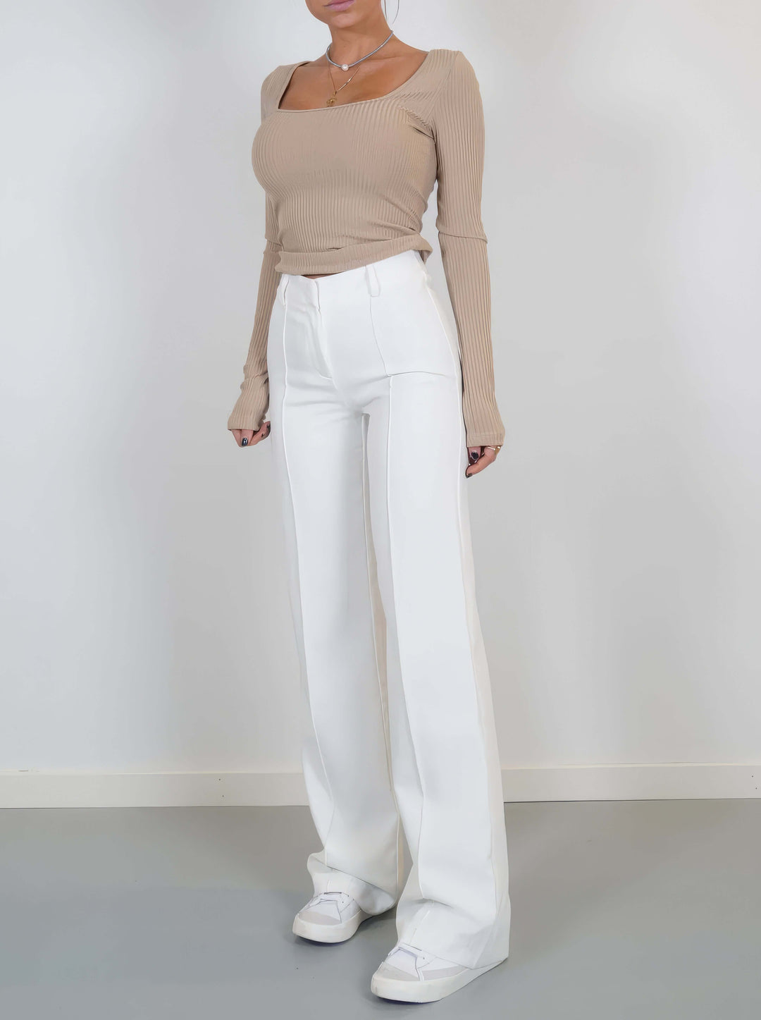 Stylish white wide leg trousers made from soft polyester, offering a chic and versatile option.