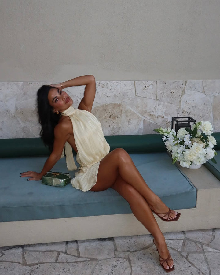 Elegant cream halter neck mini dress for women, a sophisticated choice for summer parties & holidays.