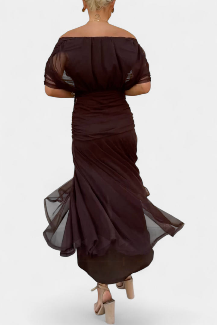 Women's elegant off-shoulder floral maxi dress worn outdoors, flowing purple & pink summer party attire.