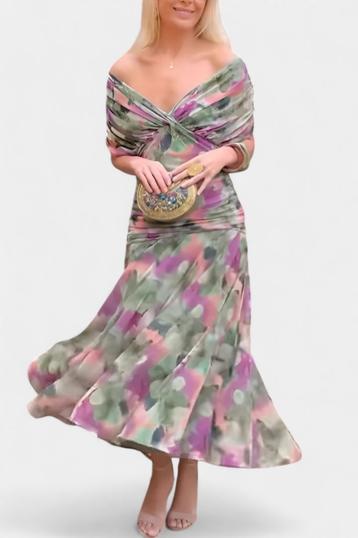 Elegant off-shoulder floral maxi dress for women indoors, flowing purple & pink occasion wear.