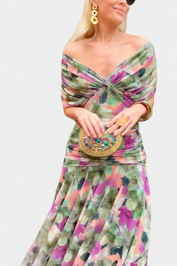 Full length of woman in elegant off-shoulder floral maxi dress, flowing purple & pink summer party gown.