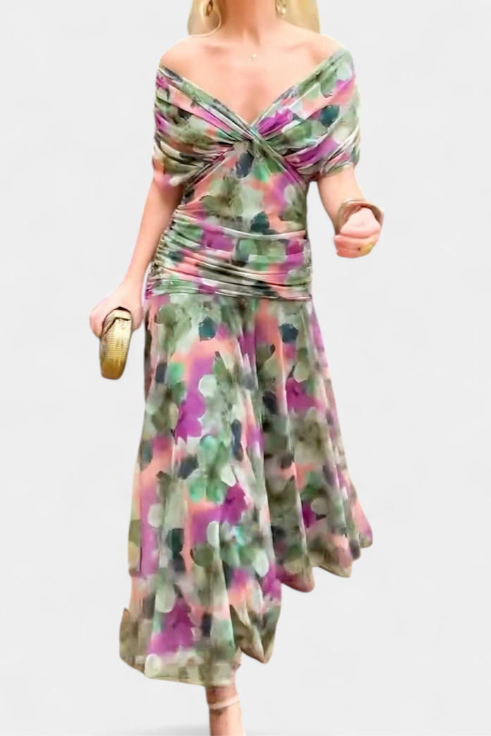 Woman standing in elegant off-shoulder floral maxi dress, flowing purple & pink summer party gown.