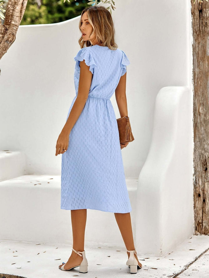 Versatile women's elegant midi dress. Flowy V-neck and ruffled sleeves suitable for casual, party or occasion wear.