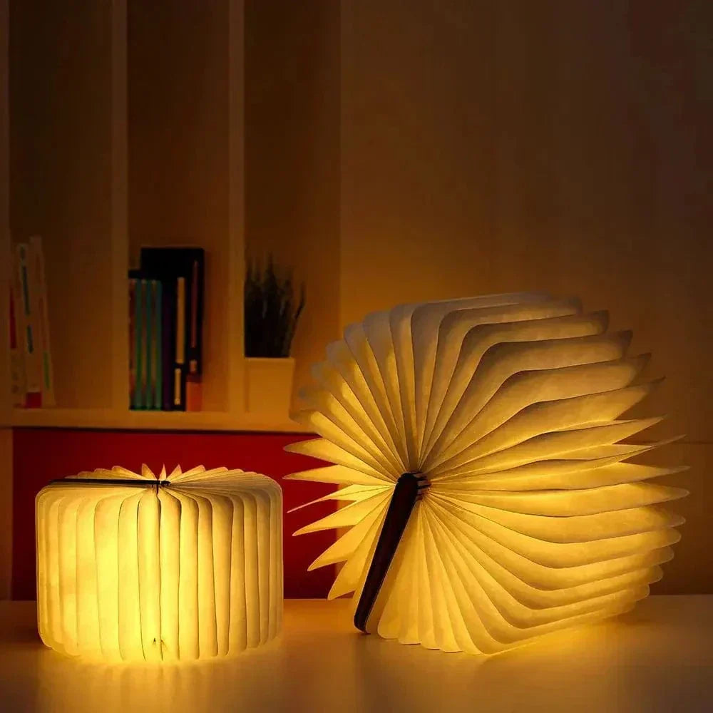 "Elegant foldable LED book lamp, warm white light, 360-degree design, portable for home or travel, wood and paper material."