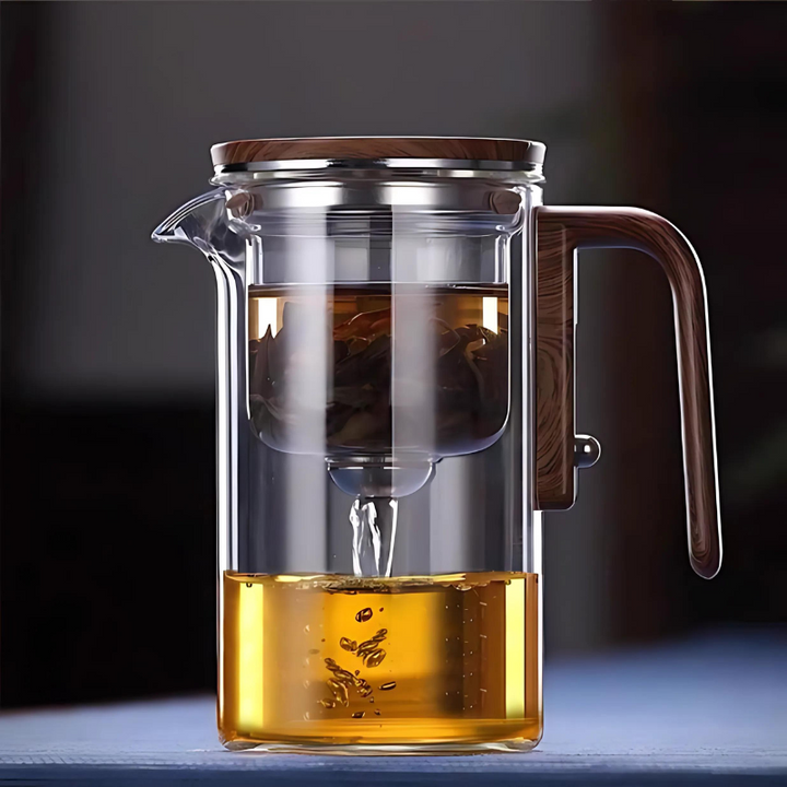 Elegant glass tea infuser on wooden base, showcasing innovative water separation technology, ideal for hot and iced tea brewi