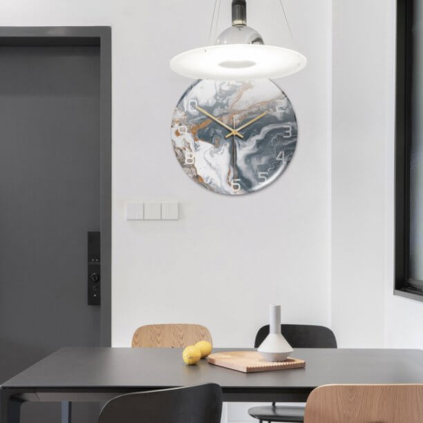 Elegant marble-look wall clock for contemporary decor, a stylish and functional timepiece.
