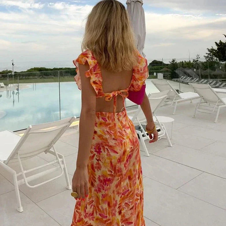 Flowy women's elegant orange maxi dress with delicate ruffles and chic batwing sleeves, ideal for special occasions.