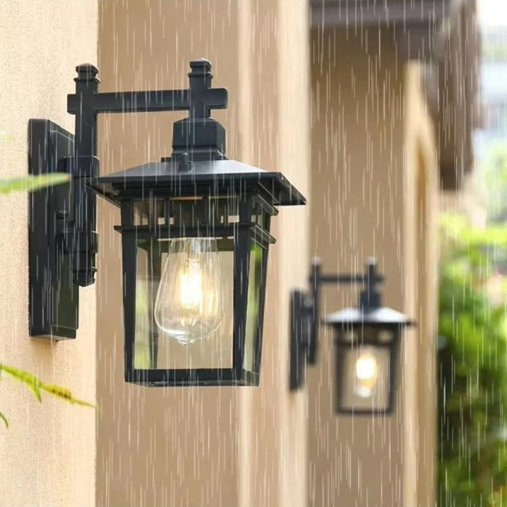 "Elegant outdoor waterproof lantern wall light with black finish and glass shade, perfect for gardens and porches."