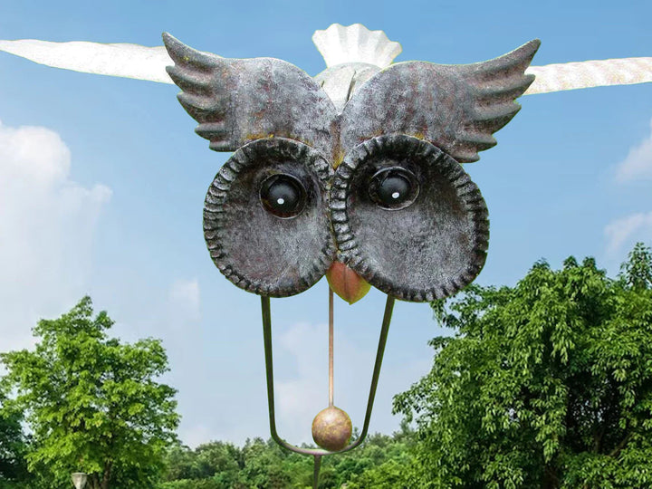 Beautiful rotating garden windmill sculpture, intricate metal art decor.