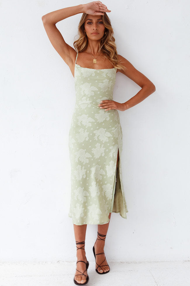 Women's orange floral midi slip dress featuring a flattering cowl neck and chic high side slit.