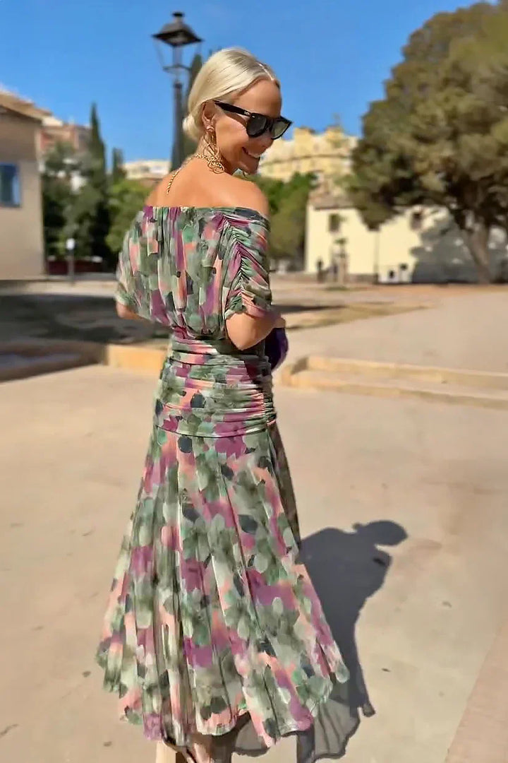 Elegant V-neck and vibrant fantasy print detail on a women's flowing maxi party dress.