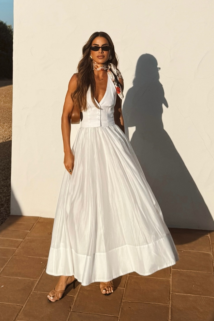 Women's long white summer party dress with a flowing silhouette and v-neck, ideal for elegant occasions.