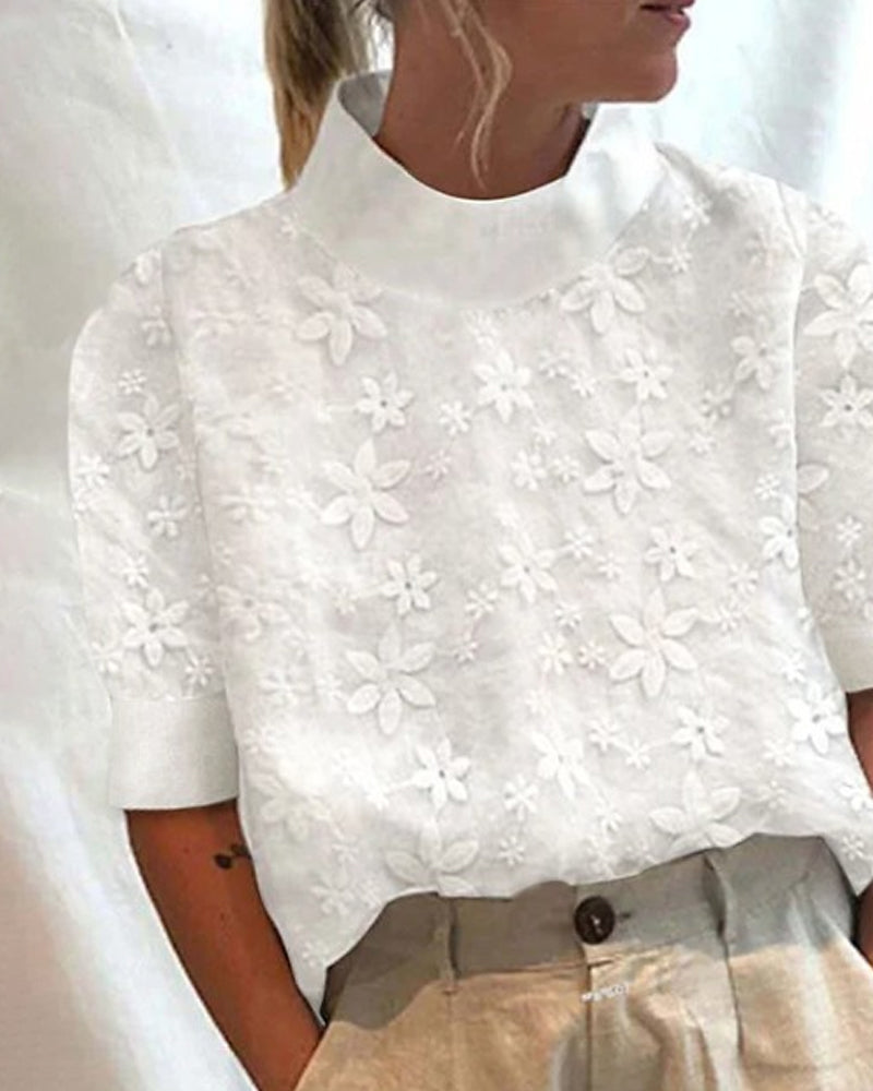 Fashionable white women's top with intricate embroidery, a high stand-up collar, and long sleeves for sophisticated style.