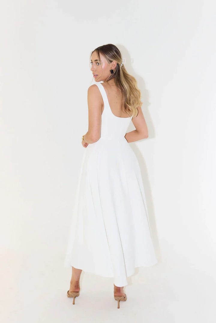 Sleeveless white midi cocktail dress for women. Features an elegant square neck & flared skirt, ideal for summer parties.