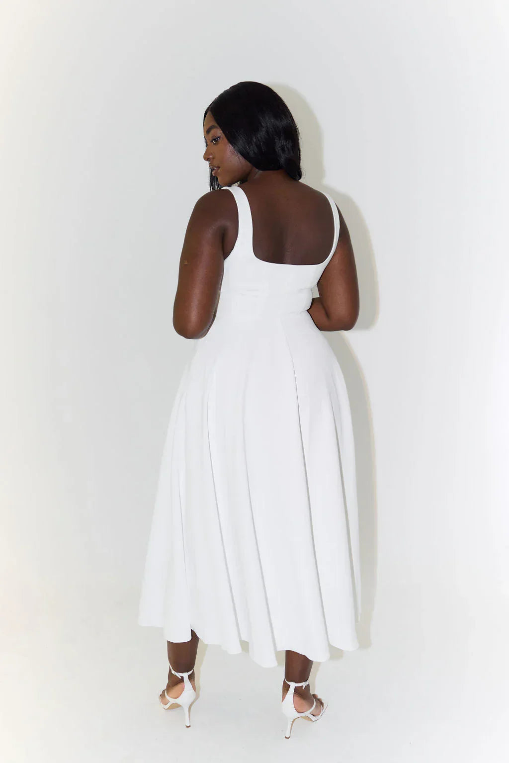 Versatile white women's elegant midi dress. Perfect as a sleeveless cocktail or formal dress with square neck & flared skirt.