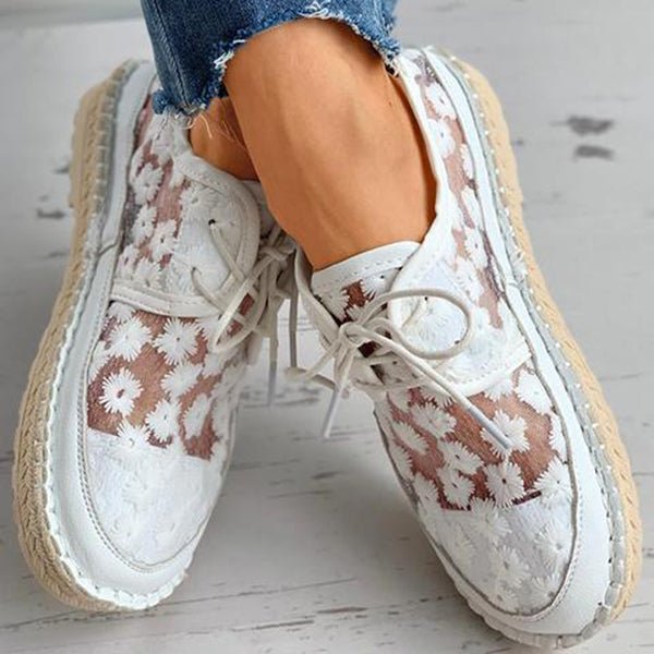 Stylish beige women's mesh sneakers with delicate floral embroidery & classic lace-up design.