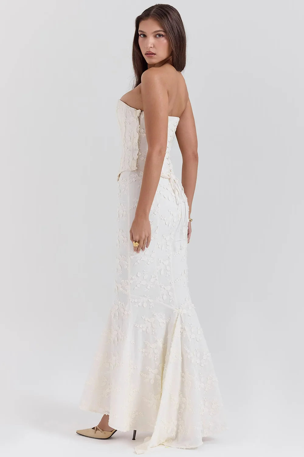 White strapless embroidered maxi dress with elegant design, suitable as a wedding guest or evening dress.