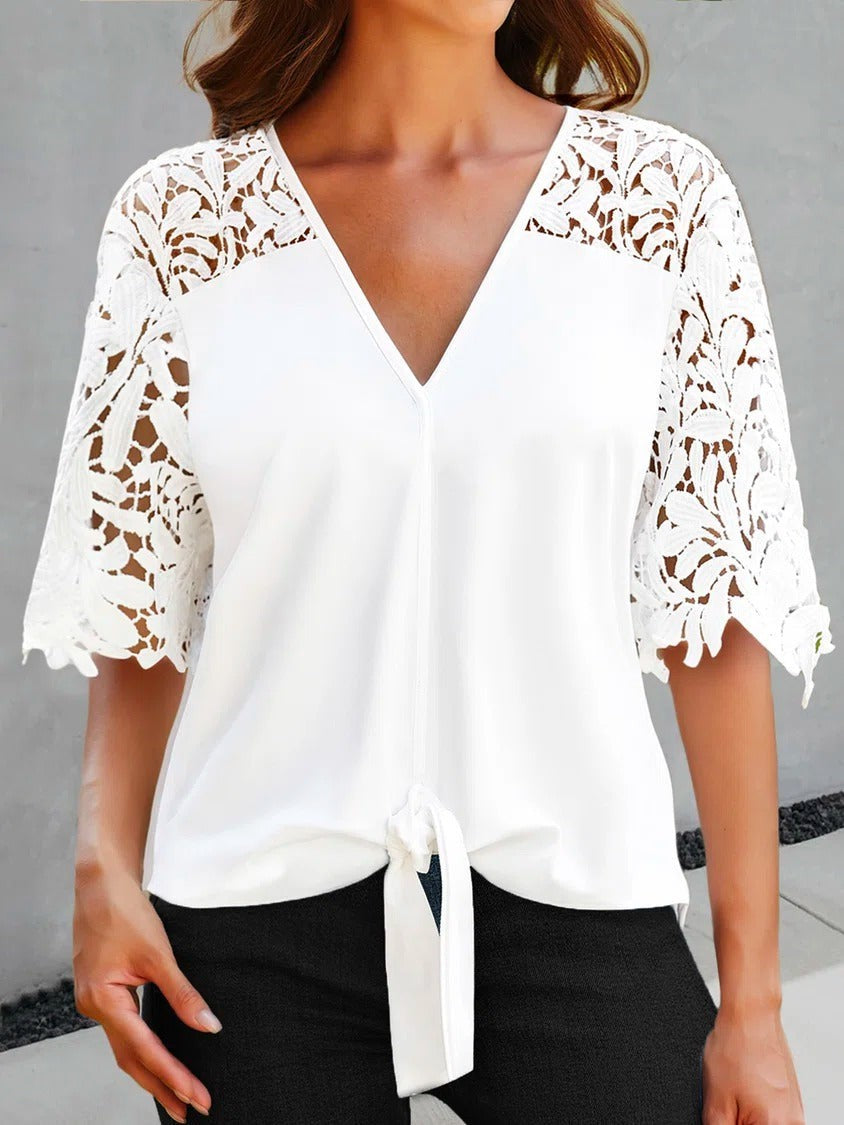 Elegant white women's V-neck blouse with intricate lace sleeves, perfect for summer casual or spring fashion.