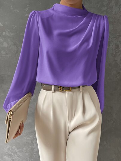 Fabric texture of an elegant women's bishop sleeve blouse, emphasizing its luxurious feel and stylish loose fit.