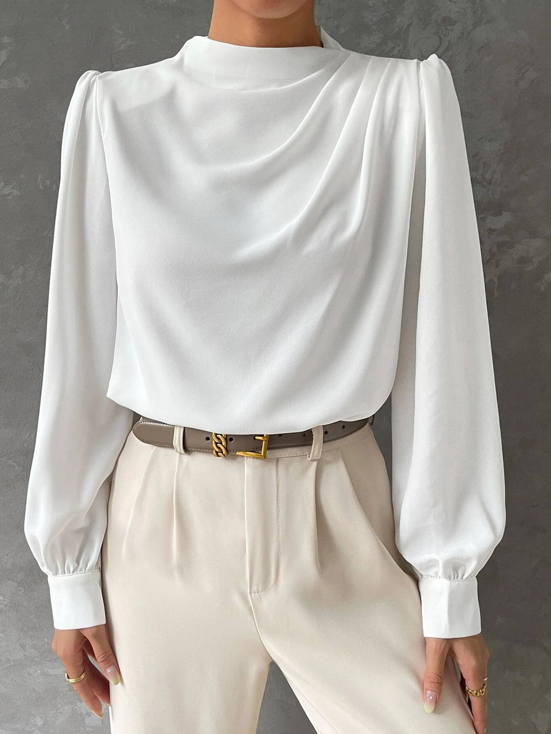 Back of a women's elegant bishop sleeve blouse. Loose fit, stylish long sleeve top for versatile office wear.