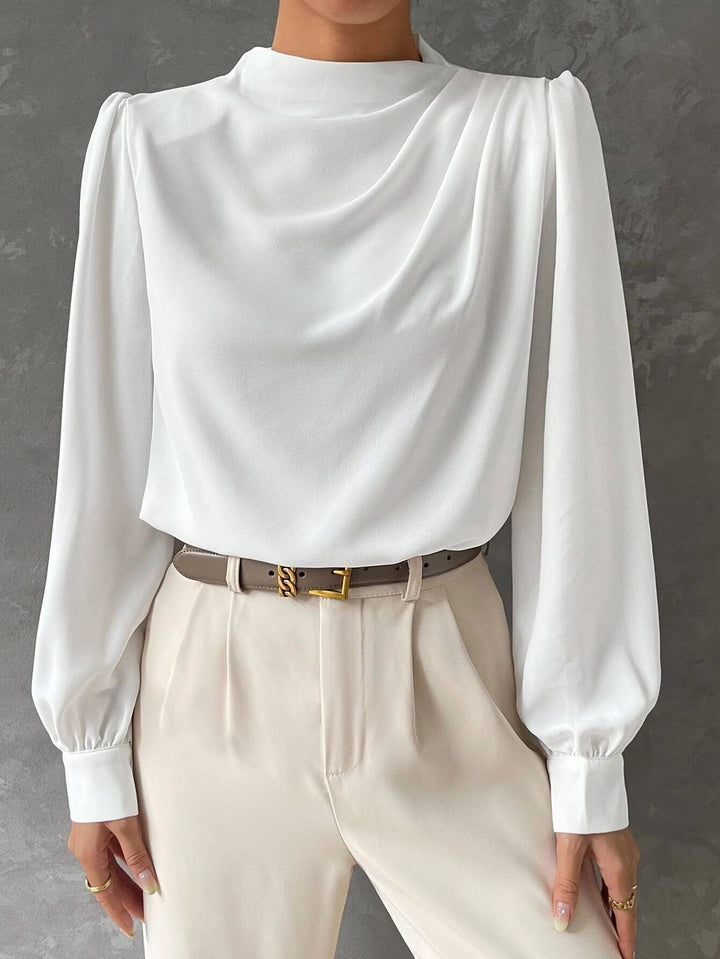 Back of a women's elegant bishop sleeve blouse. Loose fit, stylish long sleeve top for versatile office wear.