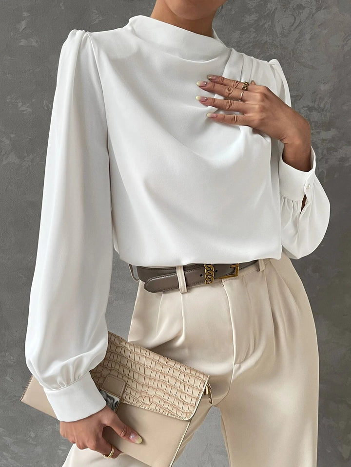 Side view of a women's long sleeve bishop sleeve blouse, showcasing its elegant, loose fit and chic design.