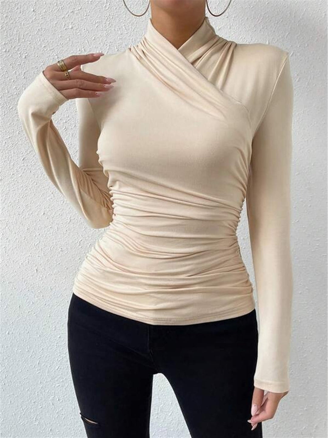 Women's sophisticated crossover long sleeve top with elegant drape, offering versatile style.