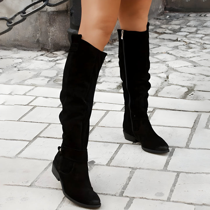 Stylish women's knee-high leather boots with non-slip tread, ideal for sophisticated winter outfits.