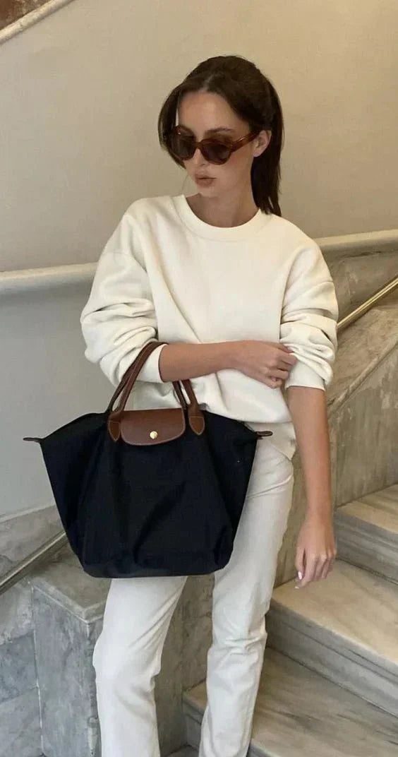 Elegant women's black shoulder bag with adjustable strap, synthetic leather. Stylish daily carry handbag accessory.