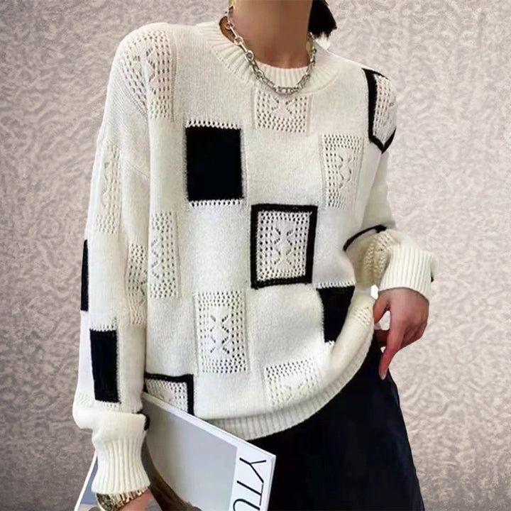 Elegant women's black & white geometric patchwork winter jumper. Cozy, stylish pullover sweater for comfort.