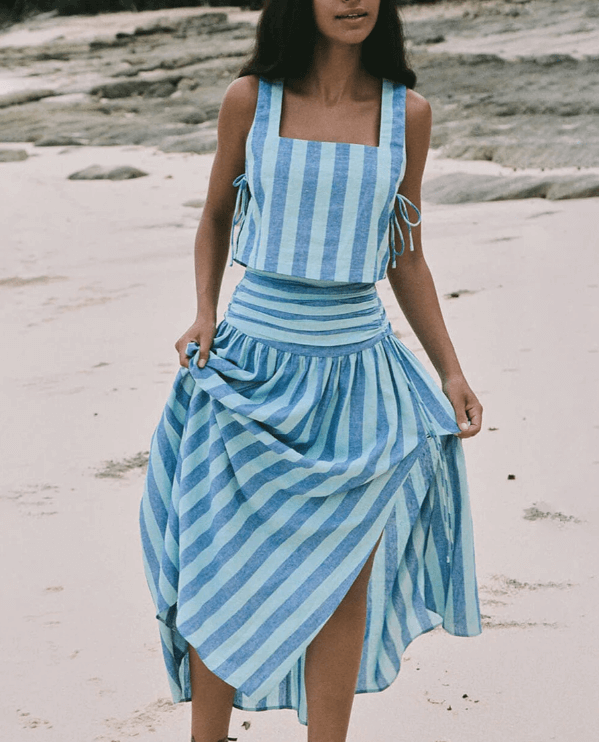 Elegant women's blue lace top and pleated midi skirt two-piece set for a stylish spring summer outfit.