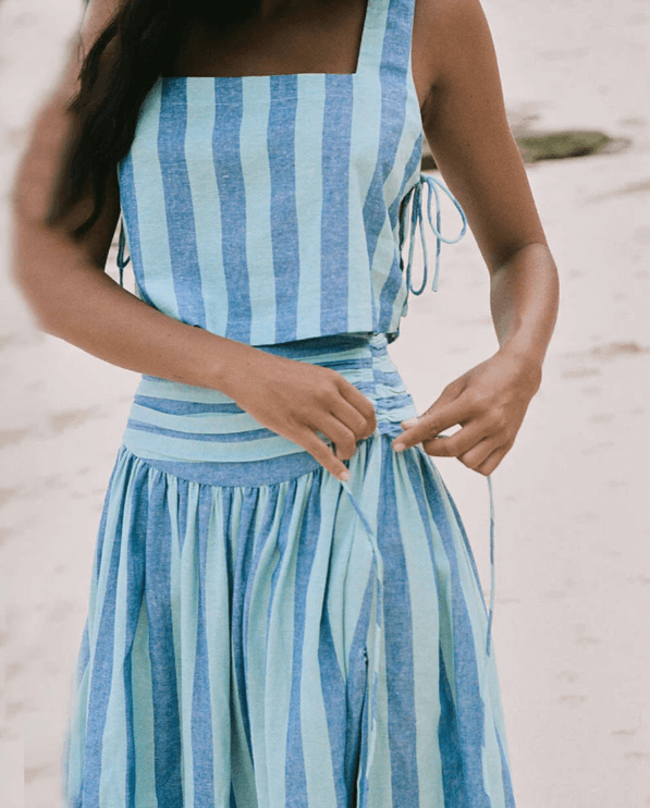 Feminine women's blue two-piece set with a lace top & pleated midi skirt, perfect for casual chic or formal wear.