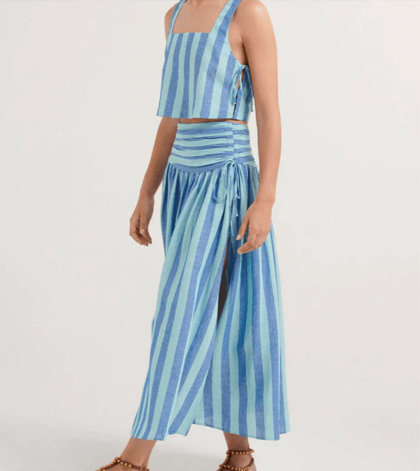 Complete women's blue elegant set featuring a delicate lace top and a graceful pleated midi skirt, ideal for parties.