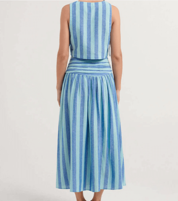 Women's elegant blue lace top and pleated midi skirt set. A chic two-piece outfit for feminine spring fashion.