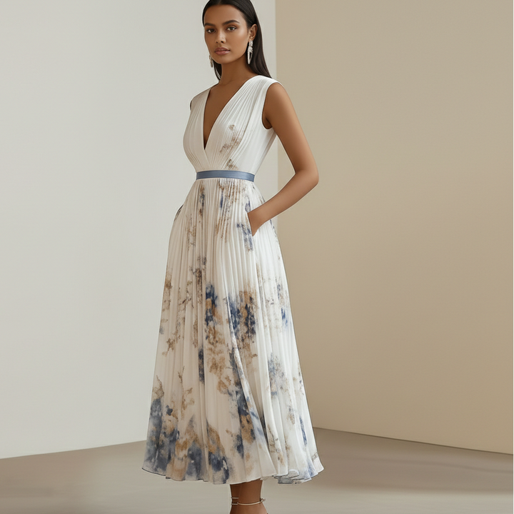 Flowy blue and white floral maxi dress for women, sleeveless and pleated, ideal for ceremony or evening wear.