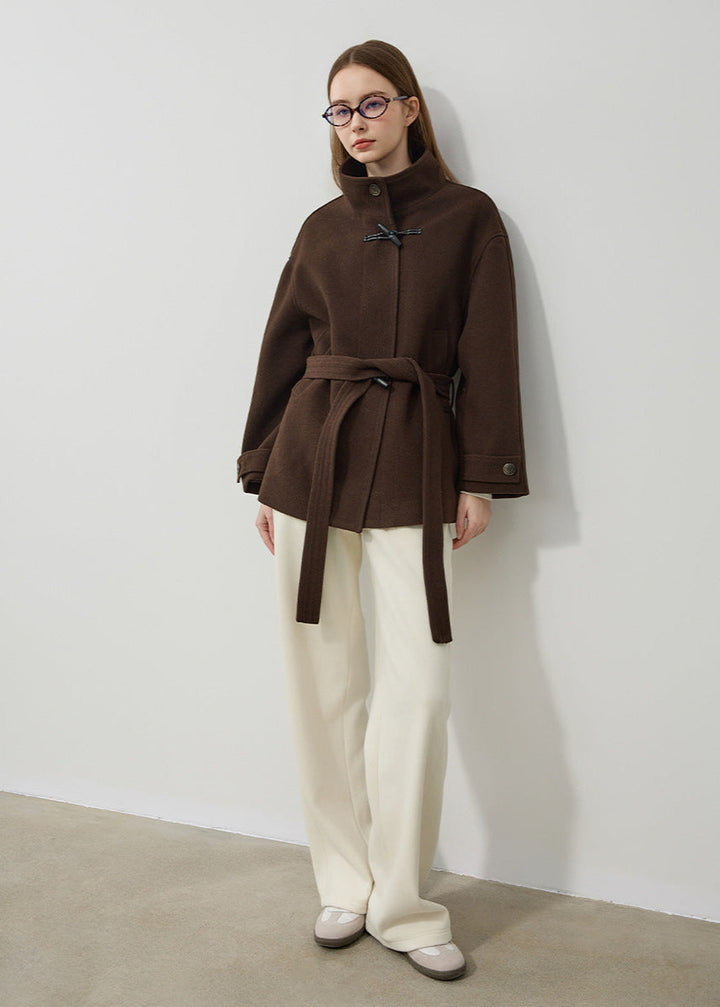 Stylish women's toggle coat in brown, featuring an elegant design & belted waist. Perfect classic winter outerwear.
