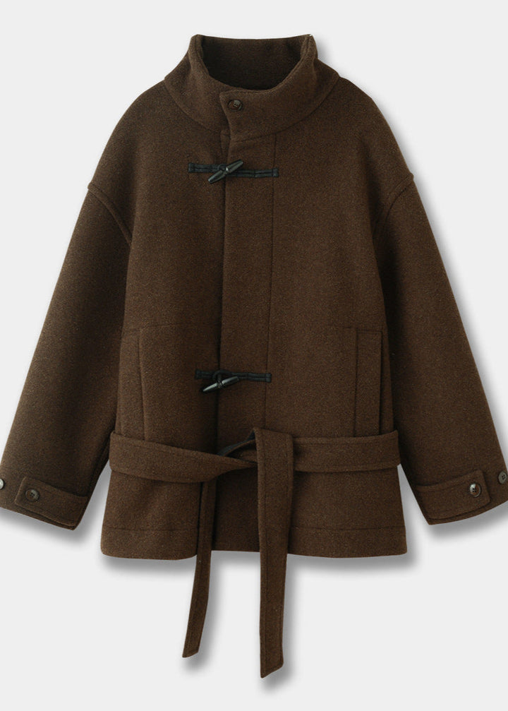 Fashionable women's elegant toggle coat. Brown winter outerwear with a stylish belted waist for a classic look.