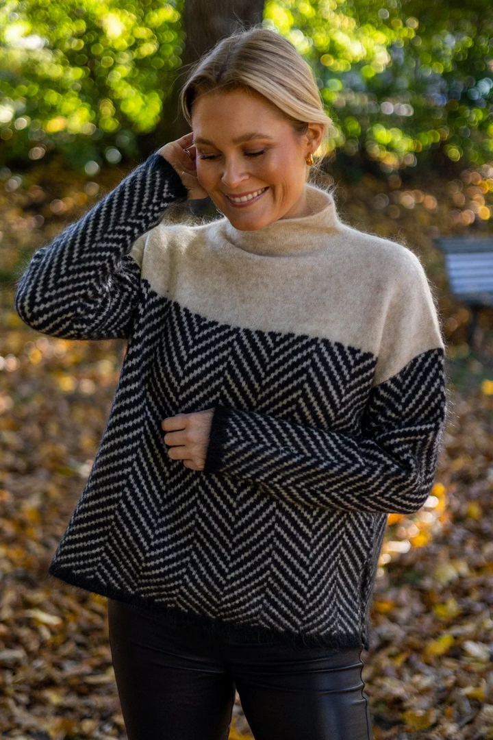 Cozy knit women's turtleneck sweater with chevron pattern, ideal for cold weather & elegant long sleeve style.