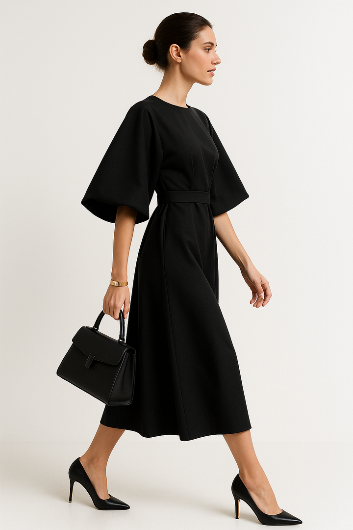 Close-up of elegant crew neck & flowing kimono sleeve on a women's sophisticated work midi dress.