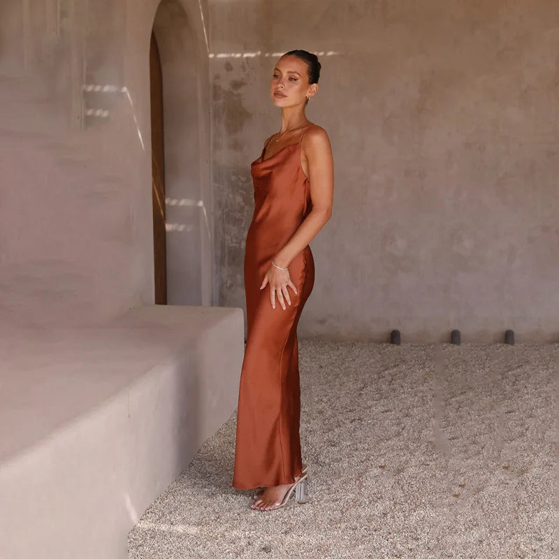 Flowy women's elegant maxi dress with a draped neckline and spaghetti straps, ideal for formal and summer events.