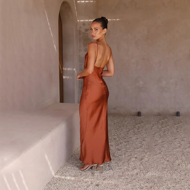 Formal women's evening gown: elegant draped maxi dress with spaghetti straps, perfect for special occasions.