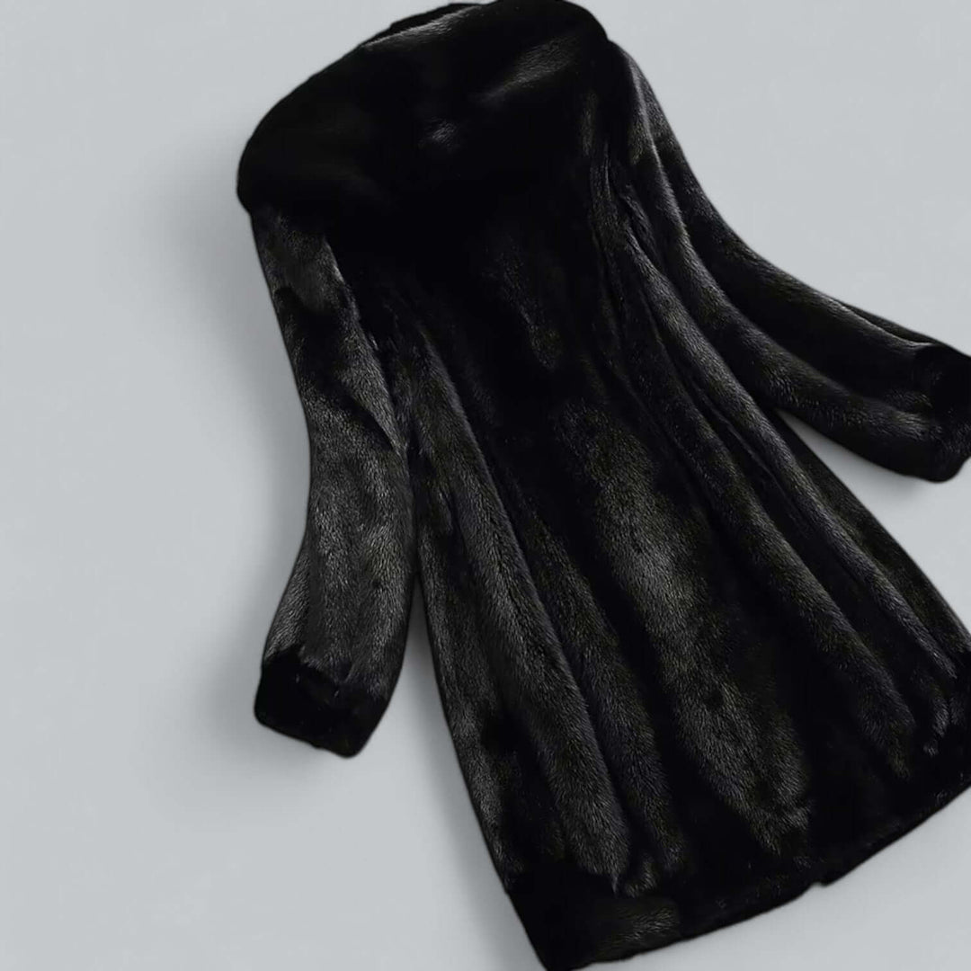 Warm & elegant women's faux fur hooded long winter coat. Perfect cold weather outerwear for luxury fashion.
